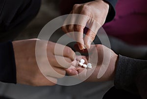Close up of addicts using drug pills photo