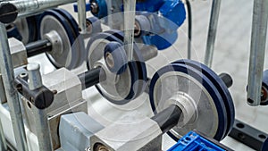 Close-up of adjustable rubber rollers on industrial conveyor processing machine