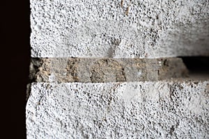 Close-up of an aerated concrete wall with an adhesive layer. Aerated concrete pores close up