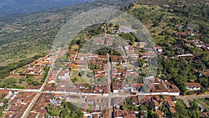 Close-up aerial view of historic town Barichara, Colombia situated on a cliff edge