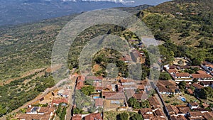 Close-up aerial view of historic town Barichara, Colombia situated on a cliff edge