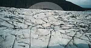 Close-up aerial view of the Vatnajokull glacier with black ash. Drone flying over the big iceberg in Iceland.