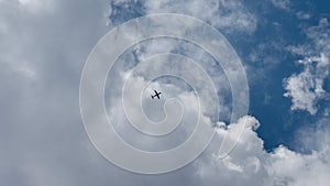 Aeroplane flying over the clouds of a blue sky