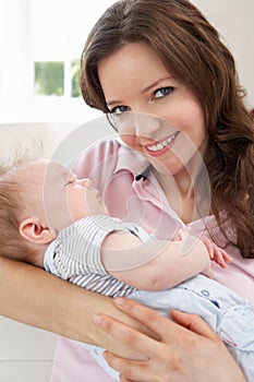 Close Up Of Affectionate Mother Cuddling Baby Boy