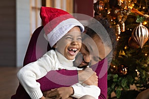 Close up African American man hugging son, celebrating Christmas