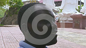 Close up african american man smiling and looking away. Portrait handscome african american man outdoor.
