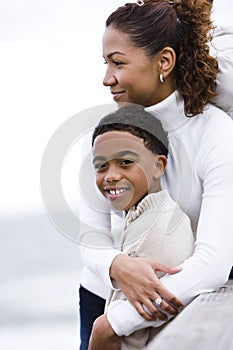 Close-up of African-American mother embracing son