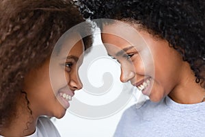 Close up African American mother and teen daughter enjoying moment