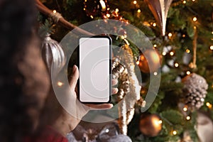 Close up African American woman holding phone, celebrating Christmas