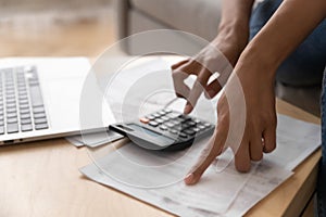 Close up African American woman using calculator, calculating finance