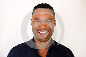 Close up african american young man smiling against white background