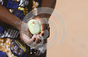 Close Up Of African Black Boy Washing Hands to Avoid Contacting Virus like Coronavirus photo