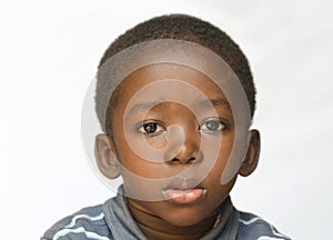 Close-up of African boy being a little sad, angry and full of despair