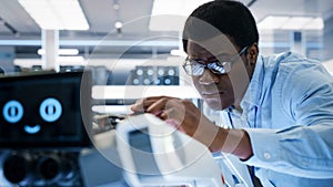 Close Up of an African Engineer Using a Screwdriver While Developing a Robot Dog Concept. Black