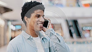 Close-up african guy looking at mobile phone answering unexpected call talking to girlfriend family smiling laughing