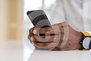 Close up of african man hands using smarpthone