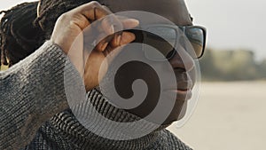 Close up, african man in the nature with sunglasses