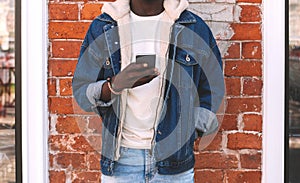 Close up african man with phone on a city street