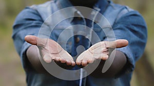 Close up. African man putting the open palms together