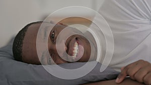 Close up African Man Talking on Video Call while Sleeping in Bed