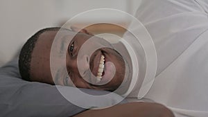 Close up African Man Talking on Video Call while Sleeping in Bed