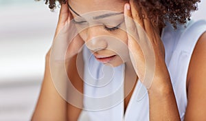 Close up of african young woman touching her head