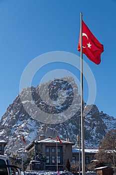 Close up of Afyon Kalesi with Turkish flags