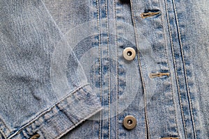 Close up aged denim texture. Old blue jeans jacket with stiched