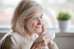 Close up of aged female thinking about pleasant life moments