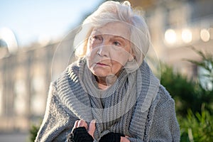 Close up of aged homeless woman wearing sweater