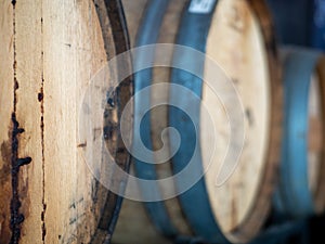 Close up of aged sealed barrels containing various wines in cellar