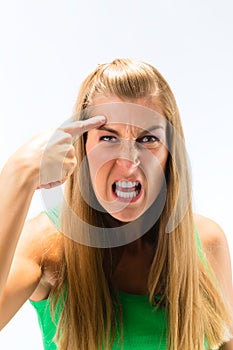 Aggressive young woman clenching her teeth photo
