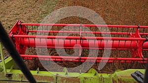 Close up of agricultural machine engaged in harvesting crops