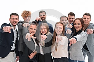 Close up . agroup of confident young business people pointing at you