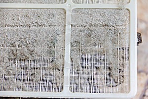 Close up on air conditioner filter is very dirty after remove from unit wait clean