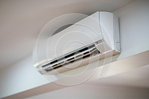 Close up of an air conditioner on a white wall photo
