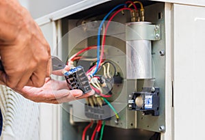 Close up of Air Conditioning Repair, repairman installing magnetic contactor and fixing air conditioning system