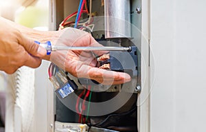 Close up of Air Conditioning Repair, repairman installing magnetic contactor and fixing air conditioning system