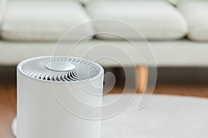Close up Air purifier in cozy white living room for filter and cleaning removing dust PM2.5 HEPA and virus in home,for fresh air