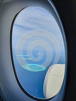 CLOSE UP: Airplane window offers a spectacular view of atolls in the Maldives.