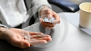 Close-up, An airsick motion sickness pill on a female hand. Healthcare concept