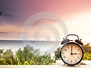 Close up an alarm clock with nature background, time concept