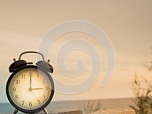 Close up an alarm clock with nature background, time concept