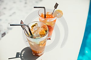 close-up of alcoholic drinks, mojito with lime and ice and gin and tonic lemonade served cold