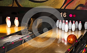 Close up of alley at bowling club. pin bowling alley background. Closeup of ten pin row on a lane, night light and sphere ball .