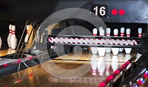 Close up of alley at bowling club. pin bowling alley background. Closeup of ten pin row on a lane, night light and sphere ball .