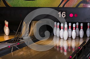 Close up of alley at bowling club. pin bowling alley background. Closeup of ten pin row on a lane, night light and sphere ball .