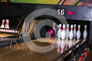 Close up of alley at bowling club. pin bowling alley background. Closeup of ten pin row on a lane, night light and sphere ball .