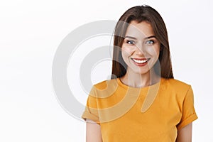 Close-up alluring happy smiling brunette woman in yellow t-shirt looking forward to exciting event, grinning joyfully