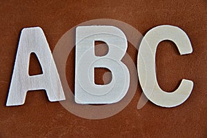 Close up alphabet on brown texture